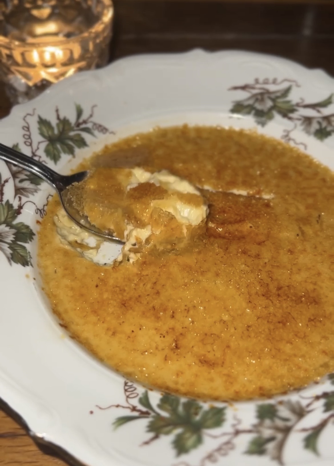 Close-up of a crème brûlée dessert by candlelight at a Sobremesa dinner